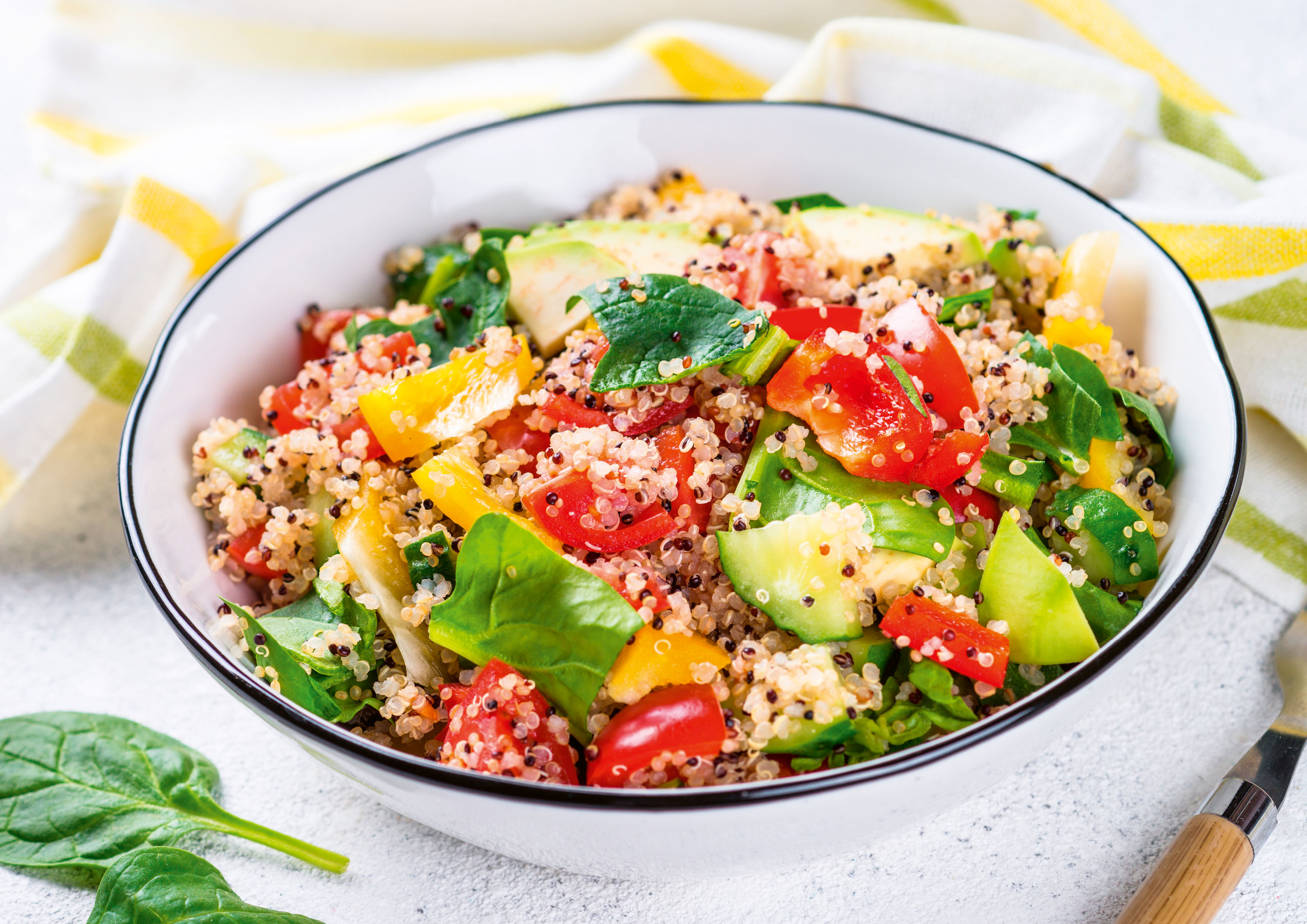 Tiefer Teller mit buntem mediterranem Gemüse, Cinoa und Spinat